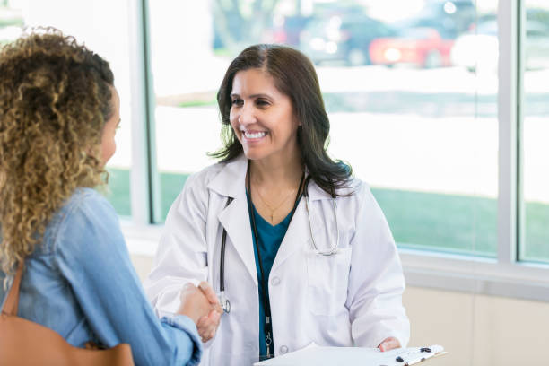 istock Cheerful doctor greets new patient 968608496