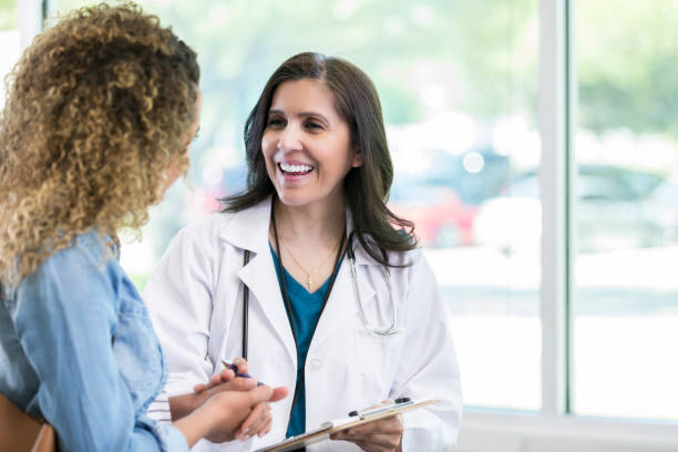 istock Cheerful female doctor talks with new patient 968608498