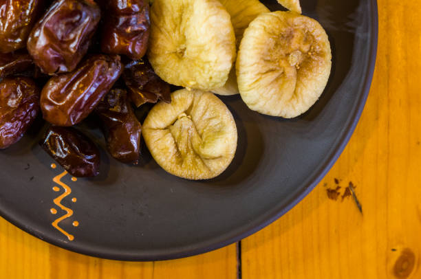 istock dried dates and figs in a ceramic plate on a wooden table 968609074
