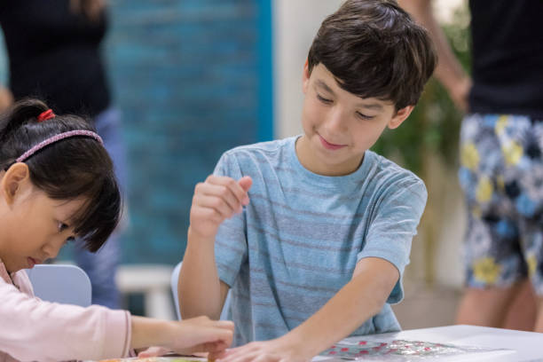istock Brother helps sister with craft at home 968611646