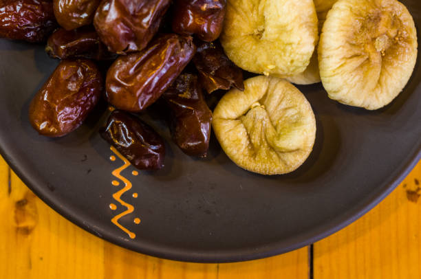 istock dried dates and figs in a ceramic plate on a wooden table 968611762