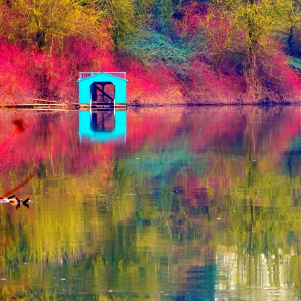 Boathouse Reflecting In Autumn stock photo