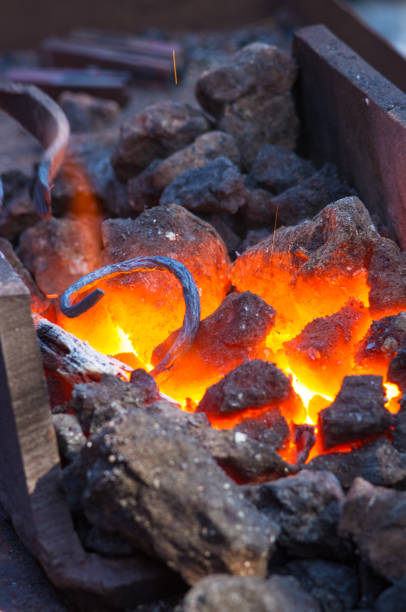 istock blacksmith furnace with burning coals, tools, and glowing hot metal workpieces 968616716