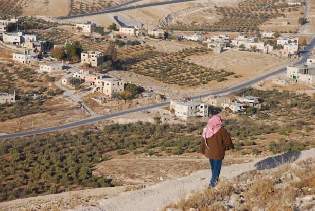 A Palestinian man walks at the Herodian above a Palestinian village in the West Bank
