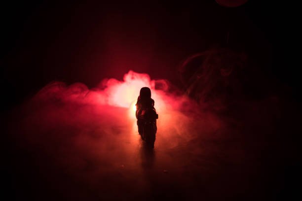 istock High power motorcycle chopper. Fog with backlights on background with man rider at night. Empty space 968631338