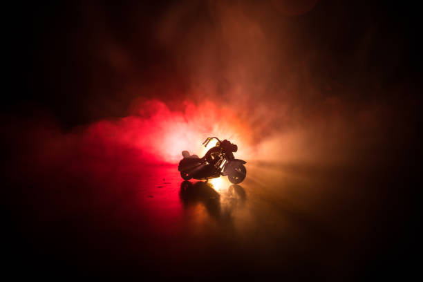 High power motorcycle chopper. Fog with backlights on background with man rider at night. Empty space