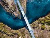 Driving on a bridge over deep blue water