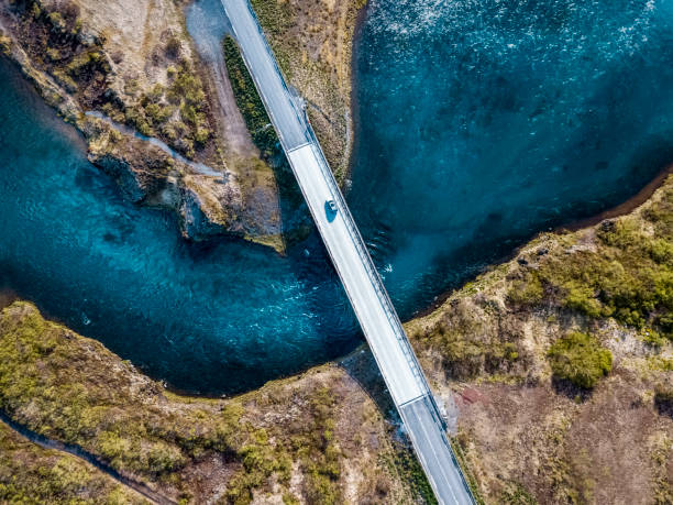 driving on a bridge over deep blue water - vista aérea de carro isolado imagens e fotografias de stock