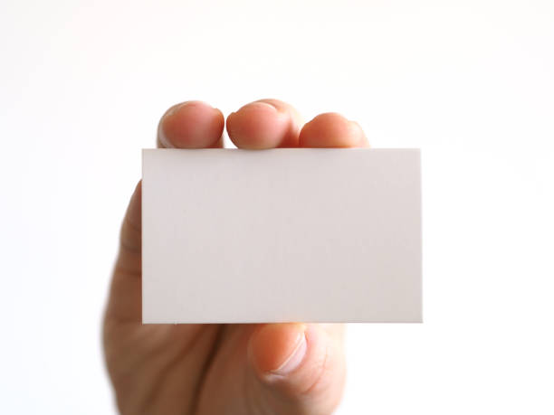 istock person with a business card in hand or note paper 968636562