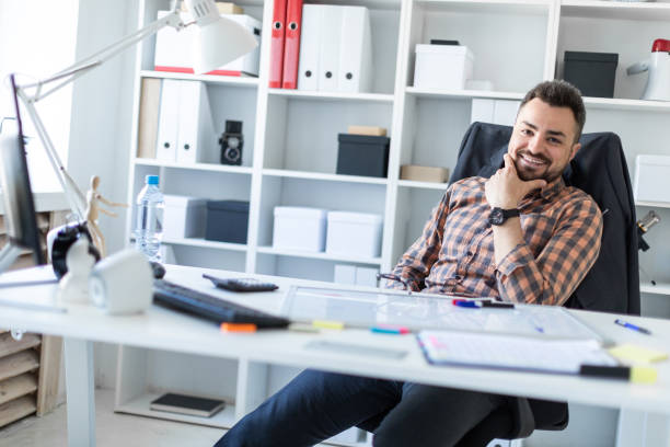 istock A man is sitting at a table in the office. 968637180