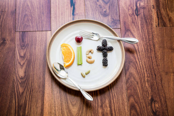 istock Food spelling diet with spoon and fork 968639522