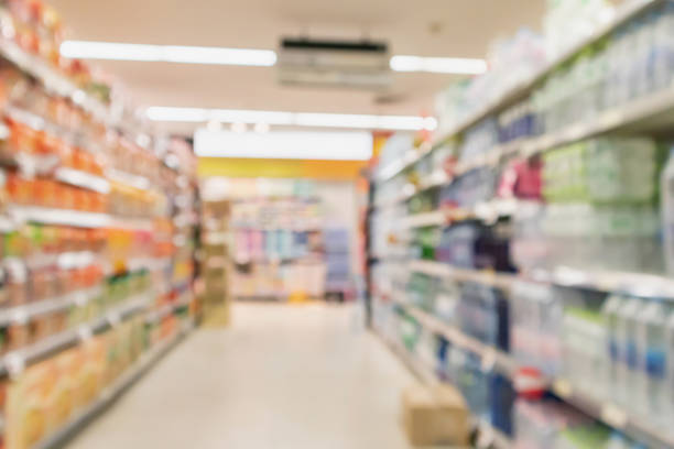 istock Empty supermarket aisle with product on shelves blurred background 968642312