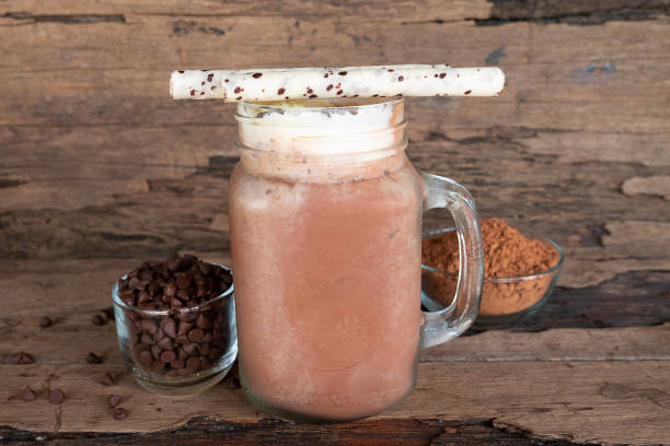 istock Chocolate and cocoa mixed with milk  smoothies on wooden floor. 968647882