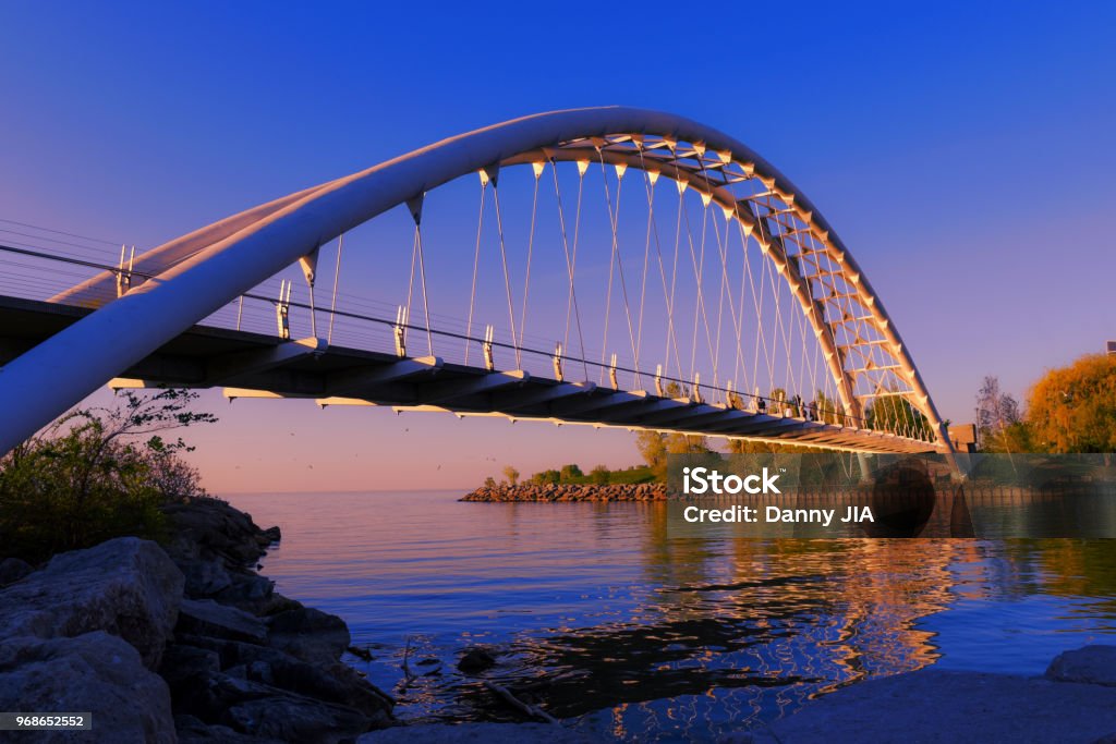 Pedestrian bridge at Lake Ontario Lake in morning light Bridge - Built Structure Stock Photo