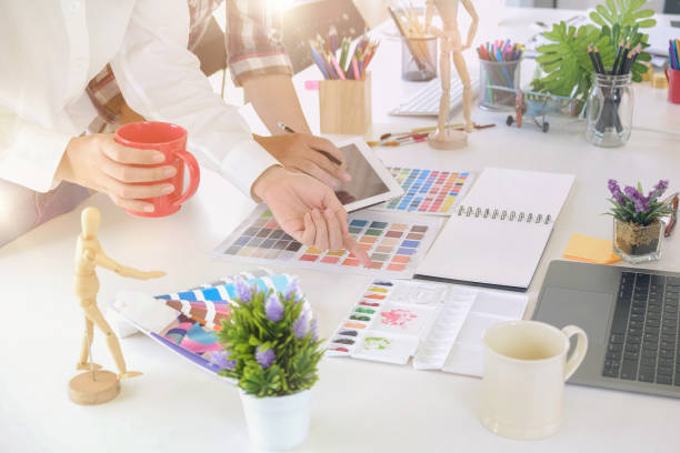 istock Team of creative designers working with tablet for new project in a design studio 968665302