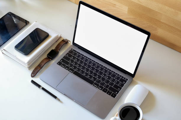 istock Mockup laptop and supplies on white table. 968665382
