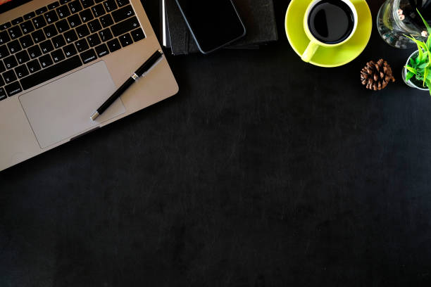 istock Office leather desk table with laptop and green coffee cup. 968665466