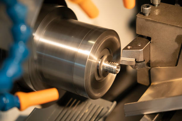 istock The CNC lathe or turning machine making the tread  at the stainless shaft. 968673978