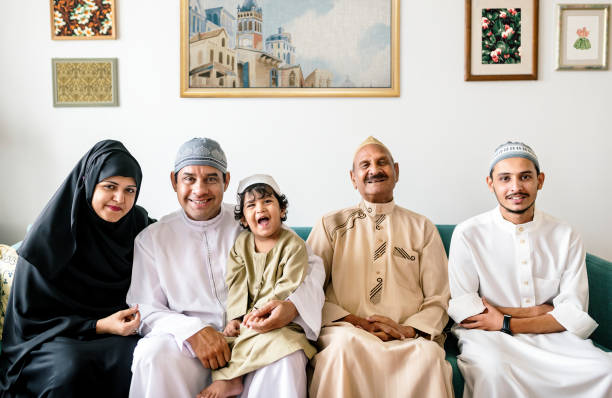イスラム教徒の家族は、家でリラックス - taqiyah ストックフォトと画像