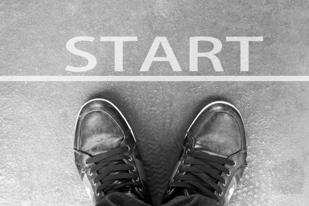 istock Start line man in sneakers standing next to white starting line 968709426