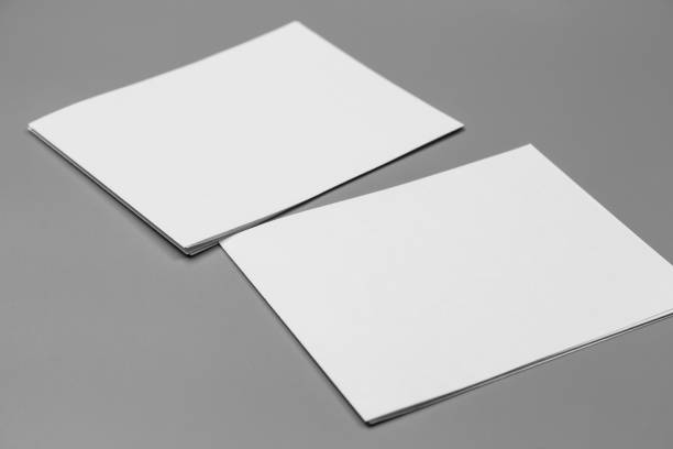 istock Blank portrait mock-up paper. brochure magazine isolated on gray, changeable background / white paper isolated on gray 968718734