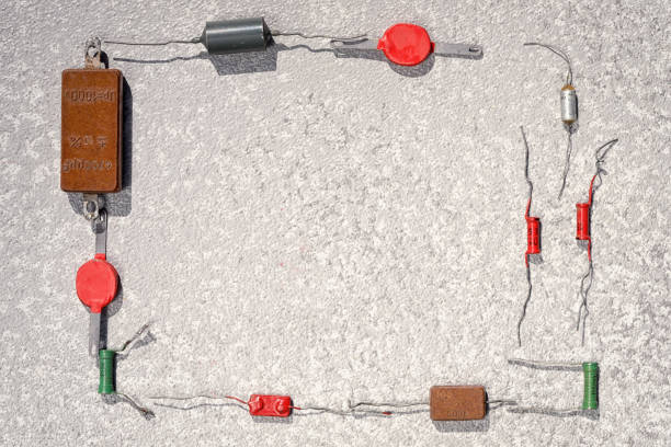 istock Old radio components as a rectangular frame. Vintage high power resistors laying at the grey cement background, top view with copy space. 968719018