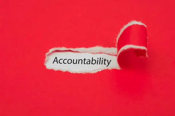 Photo of Torn red paper revealing the word of accountability concept