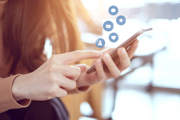 istock Woman hands using mobile smartphone with icon social media and social network. 968719222