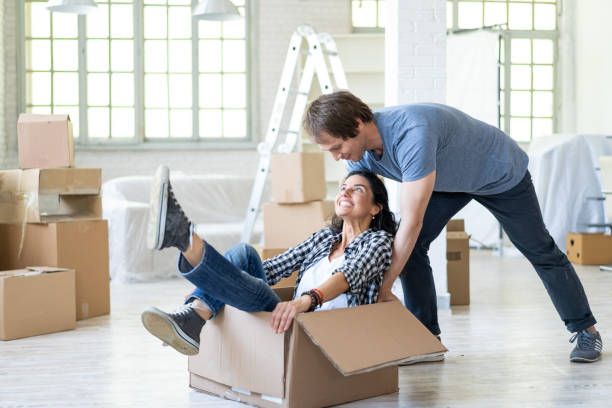 istock Happy couple in new home unpacking and having fun 968752348