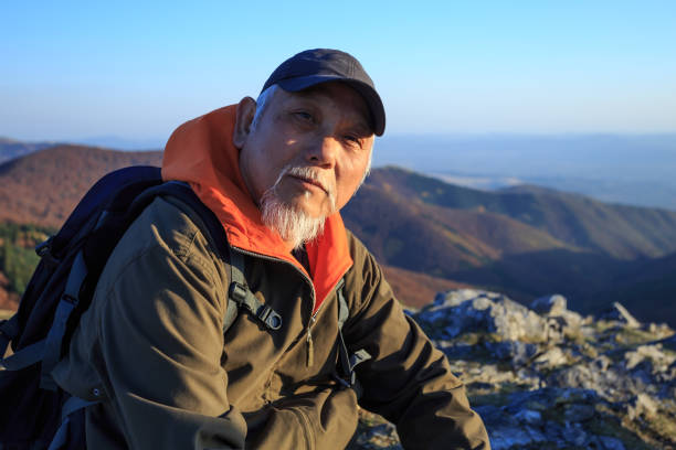 istock Senior hiker sitting on top and resting 968754450