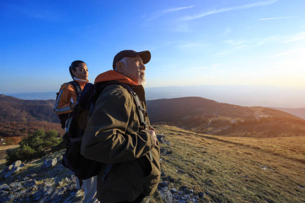 istock Tourists resting on top mountain and looking at view 968754524