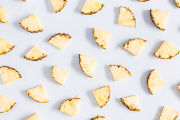 istock Pineapples on pastel blue background. Flat lay, top view 968757166