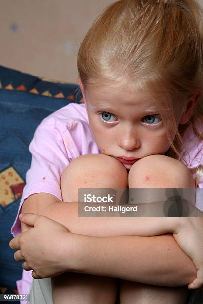 Young Girl Sitting With Her Knees Pulled Into Her Chest Stock Photo - Download Image Now