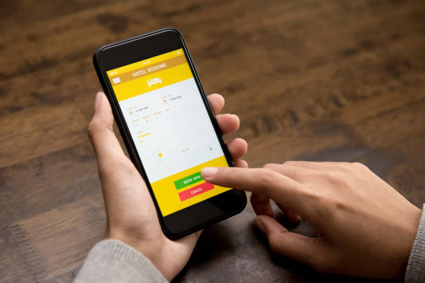 istock Woman booking hotel online using application on smartphone 968788850