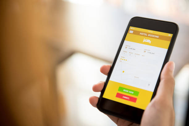 istock Woman using smartphone booking hotel online via application 968788894