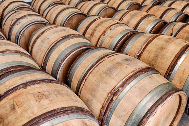 Many wooden barrels are waiting for wine in a winery near the town of Chablis in France.
