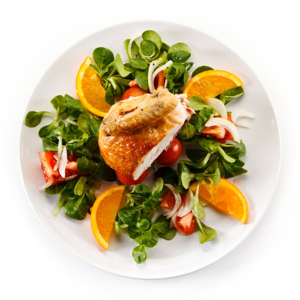 istock Roast chicken breast and vegetables on white background 968796710