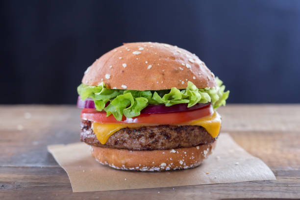 istock Burger with cheese, lettuce red onion and tomato 968796744