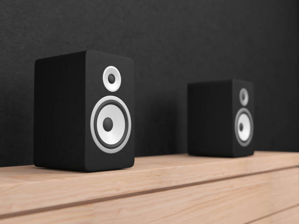 istock Black stereo Speakers with white drivers on wooden shelf 968799598