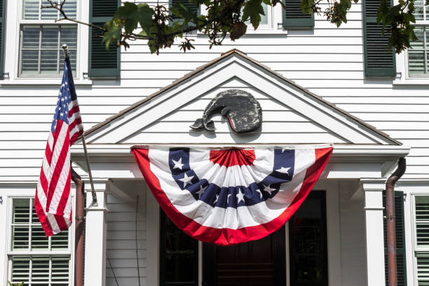 istock American flags on a colonial house 968805498