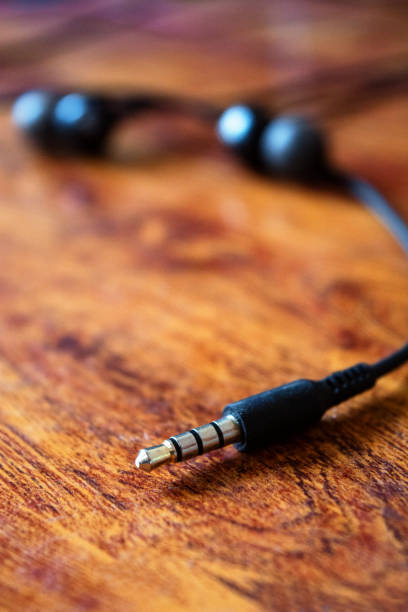 istock Earphone jack on abstract wooden background 968805786