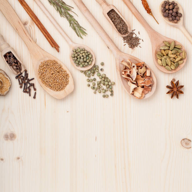 istock spices and herbs on kitchen wooden table background with copy space for text. food, cooking and restaurant concept. flat lay frame composition, top view 968806280