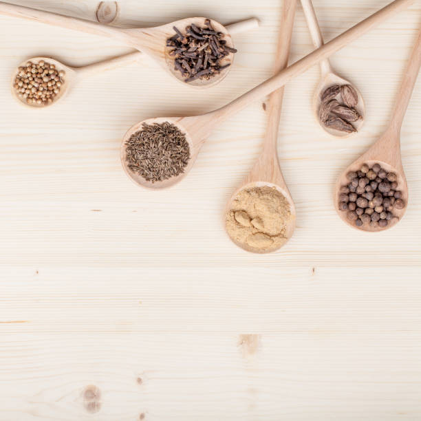 istock spices and herbs on kitchen wooden table background with copy space for text. food, cooking and restaurant concept. flat lay composition, top view 968806342