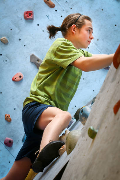 istock Teenage Boy Training Climbing On Indoor Climbing Wall 968808558