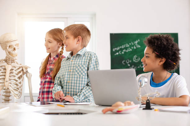 istock Nice happy children looking at the skeleton 968809732