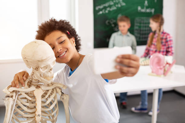 istock Positive delighted boy standing near the skeleton 968811914