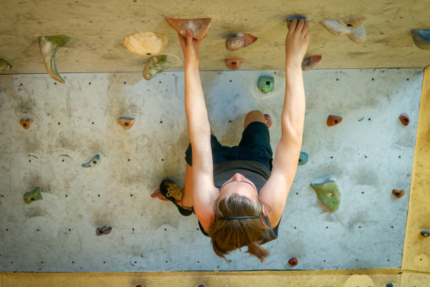 istock Teenage Boy Training Climbing On Indoor Climbing Wall 968812098