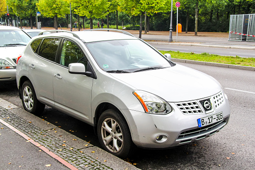 Berlin, Germany - September 12, 2013: Motor car Nissan Rogue in the city street.
