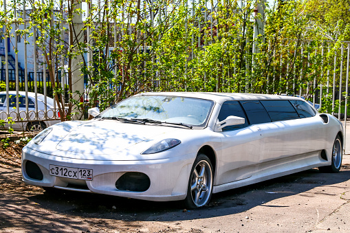 Moscow, Russia - March 3, 2018: White limousine Ferrari F430 in the city street.