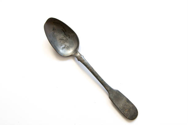 istock Antique old silver spoon isolated on white background. A kitchen vintage spoon. 968819154